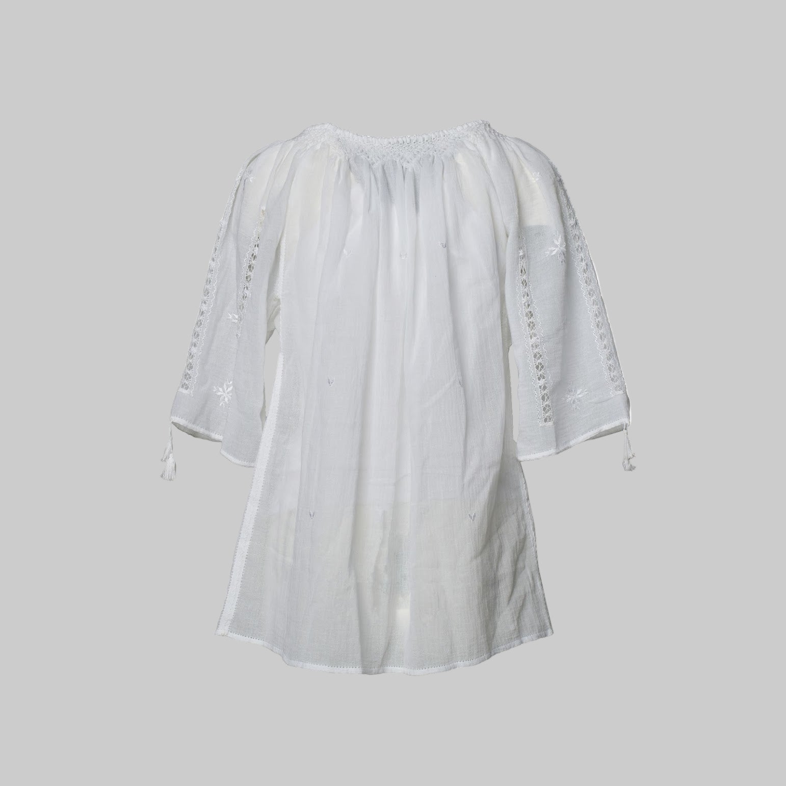 White blouse with lace details on a white background