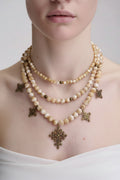 Pearl necklace with bronze pendants and cross pendant