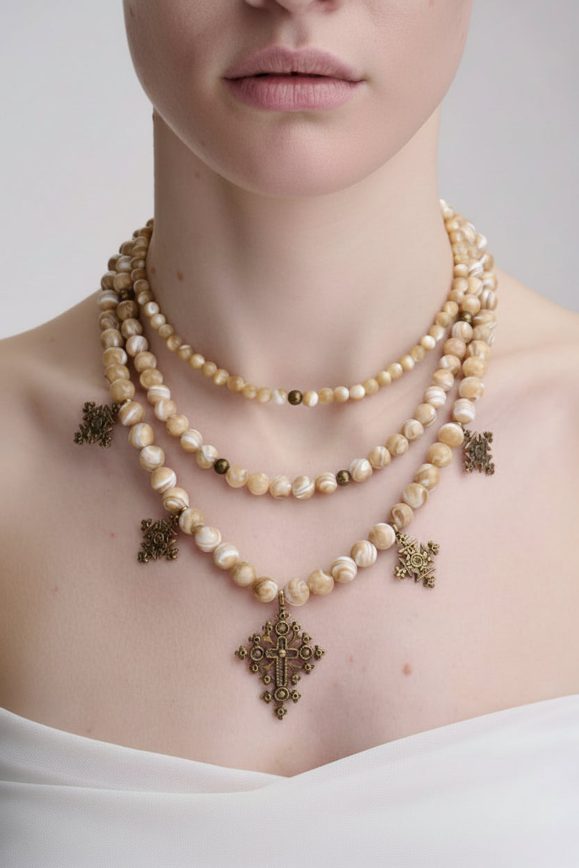 Pearl necklace with bronze pendants and cross pendant