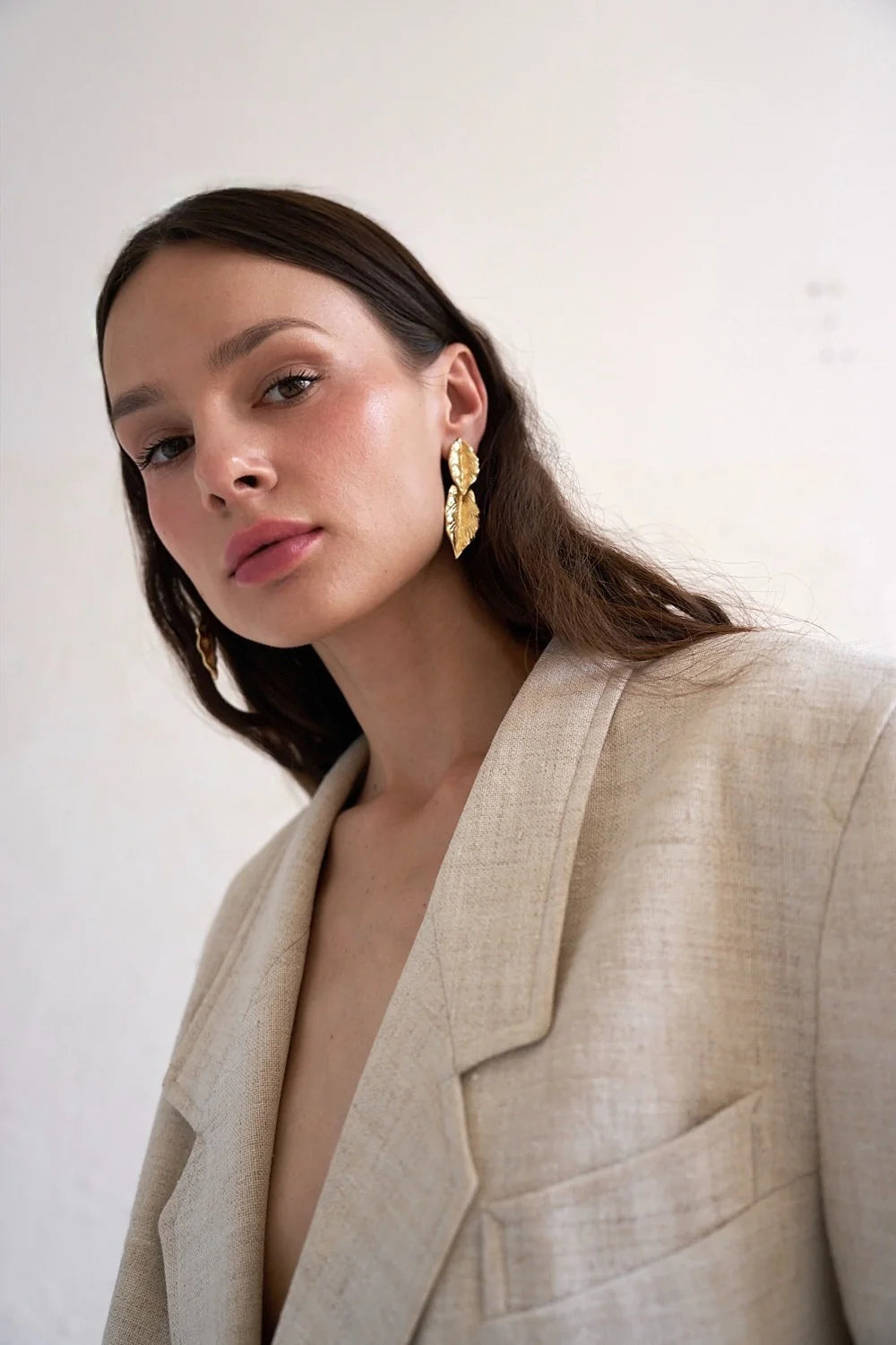 Gold leaf-shaped stainless steel earrings, side view