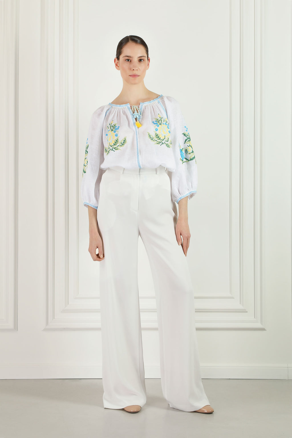 Model wearing the Evelyn white linen embroidered blouse