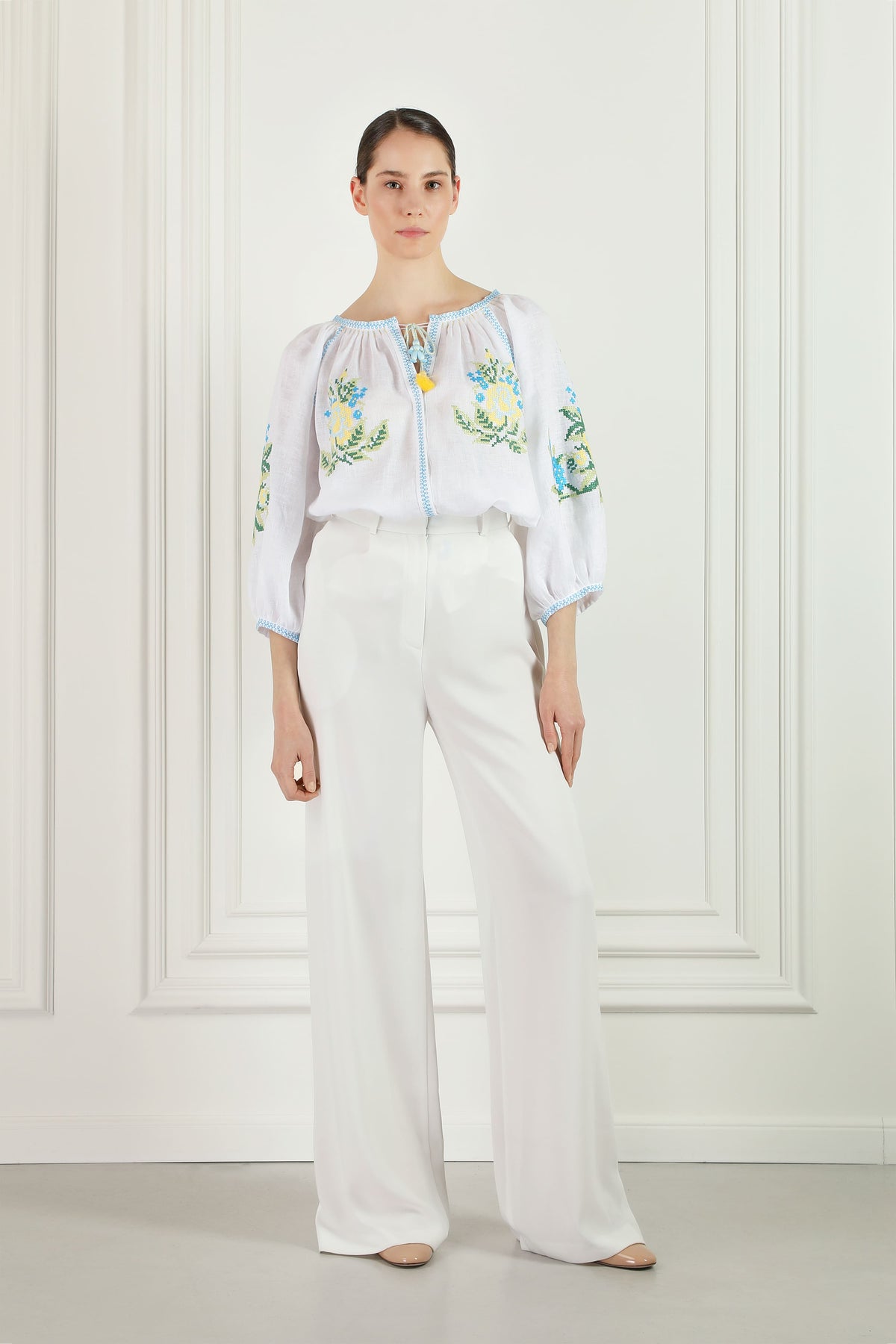 Model wearing the Evelyn white linen embroidered blouse