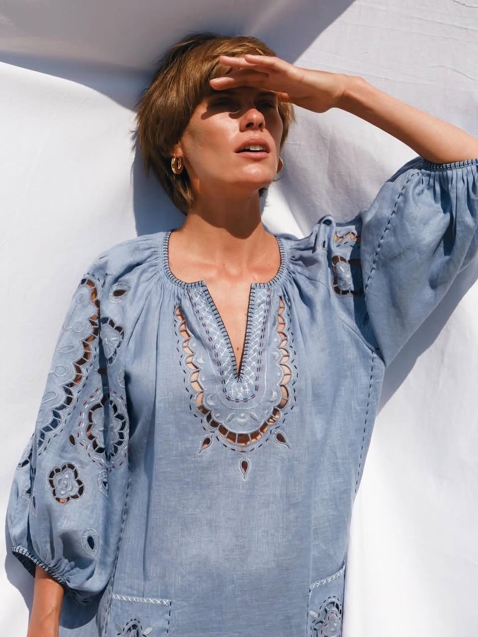 Model wearing the Merezhivo pale blue long blouse