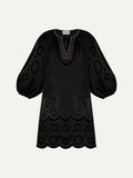 Black dress with intricate patterns on a white background
