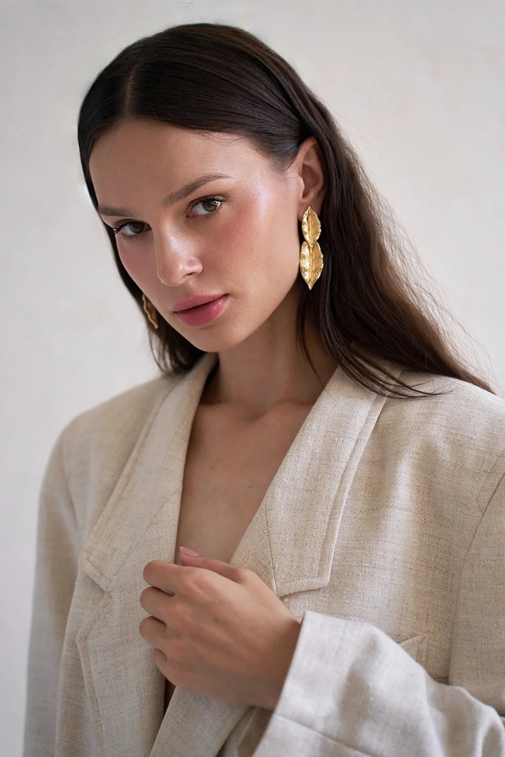 Greek-inspired gold leaf earrings, close-up