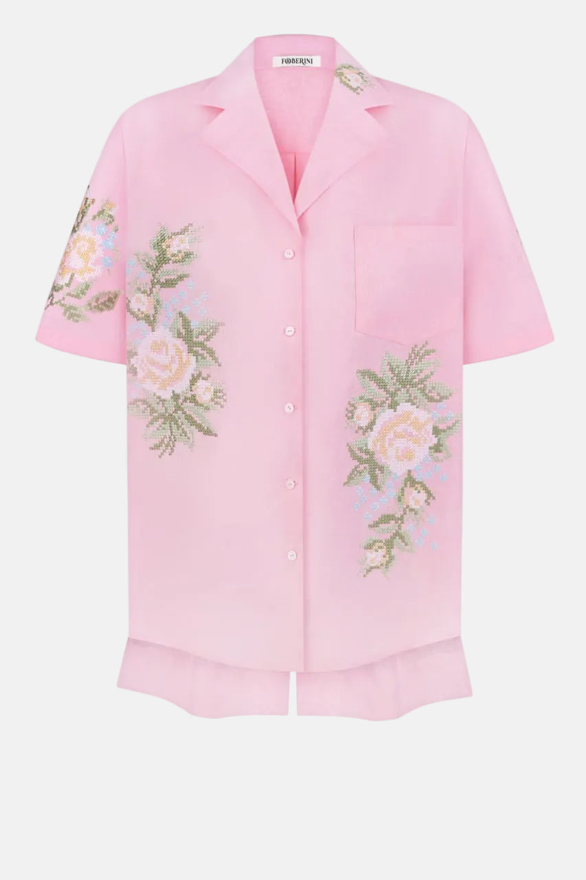 Hand-embroidered floral detail on pink linen shirt