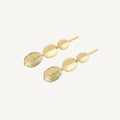 Gold leaf-shaped hairpins on a white background