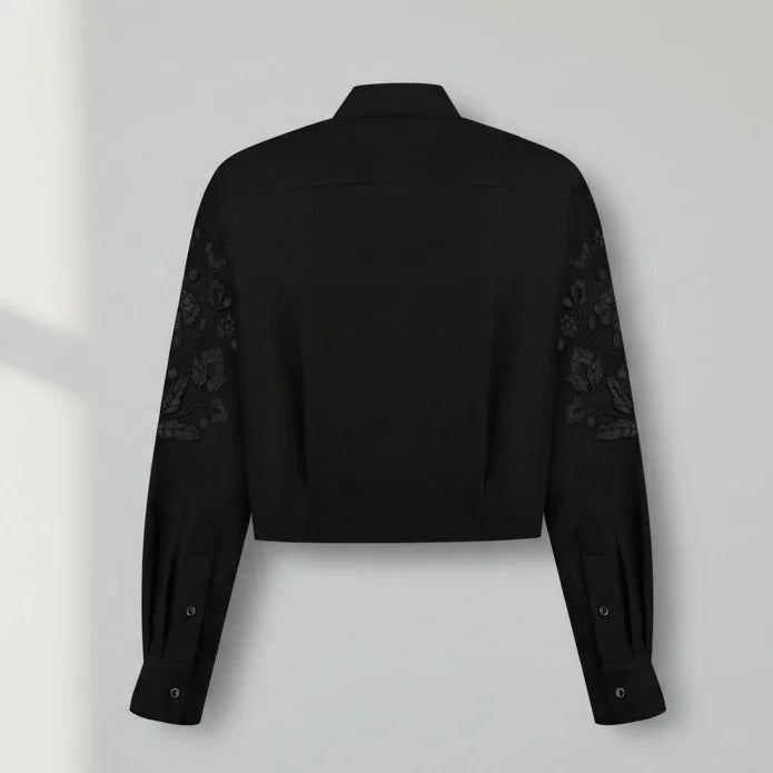 Black blouse with lace sleeves on a white background