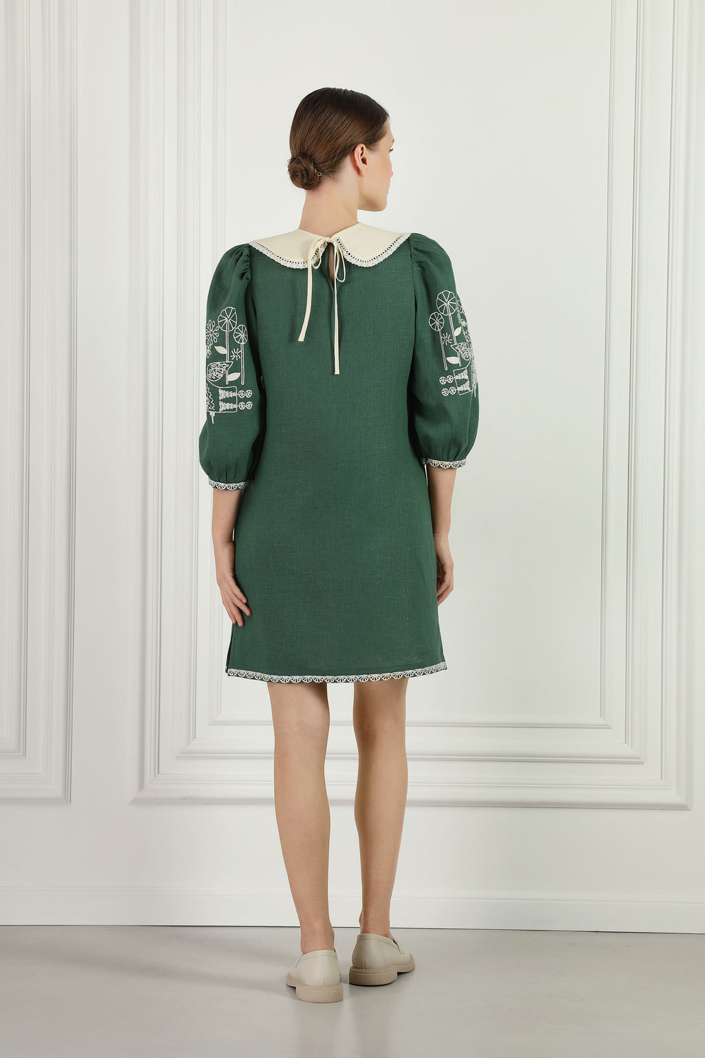 Model wearing the Zozulya green embroidered linen mini dress