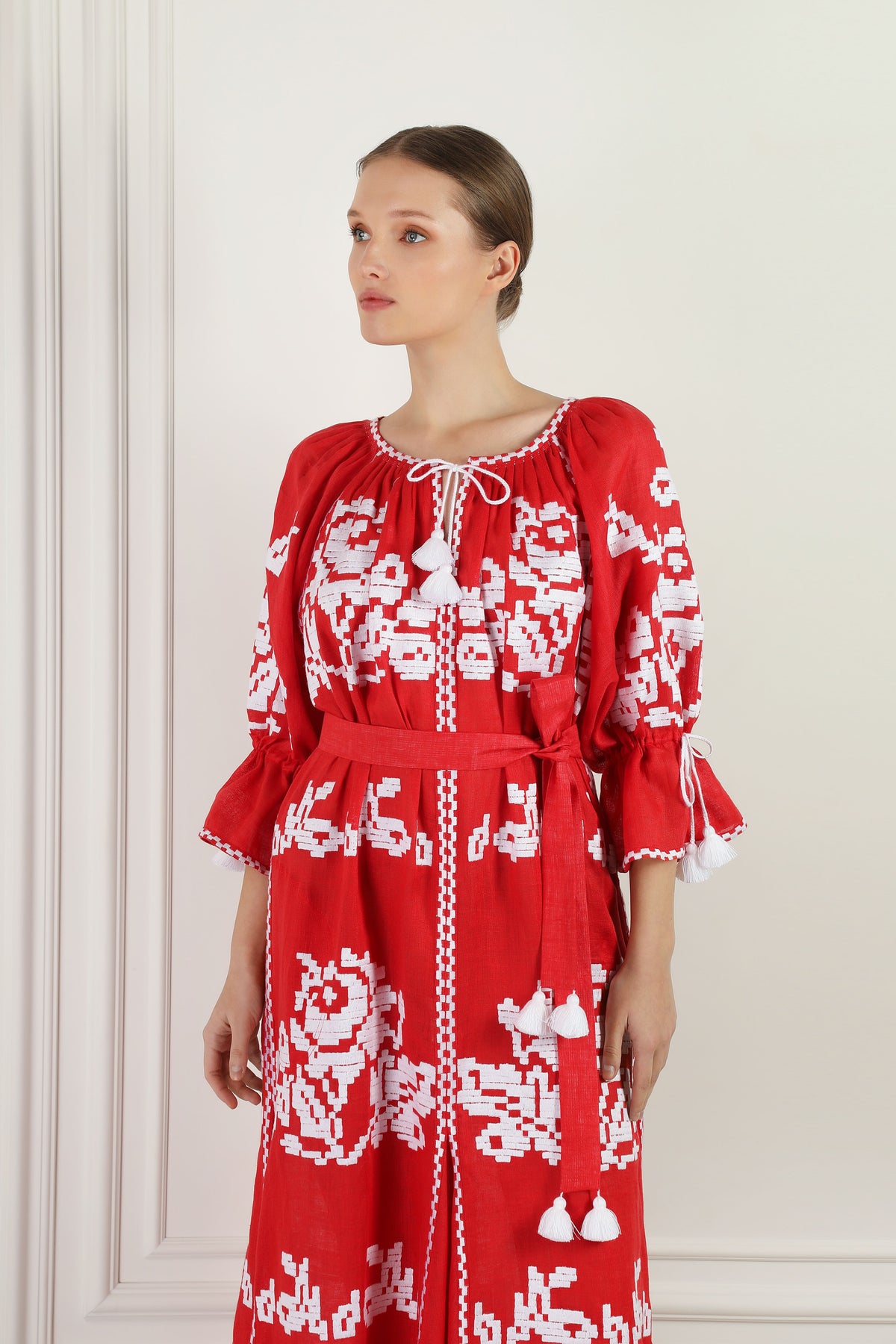 Model wearing the Red Sea embroidered red linen dress