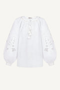 White blouse with floral embroidery on a white background