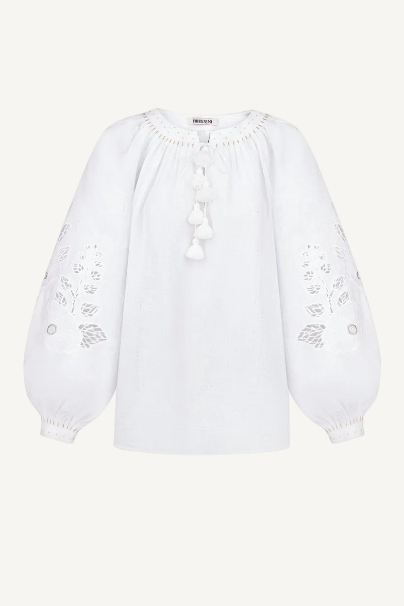 White blouse with floral embroidery on a white background