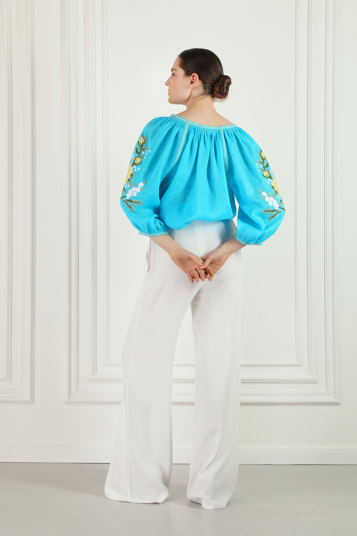 Evelyn blue linen blouse, floral cross-stitch chest embroidery detail