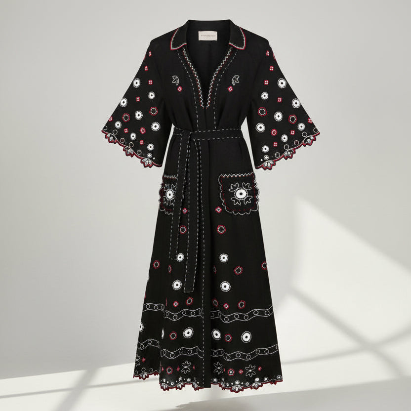 Black dress with white and pink floral patterns on a white background