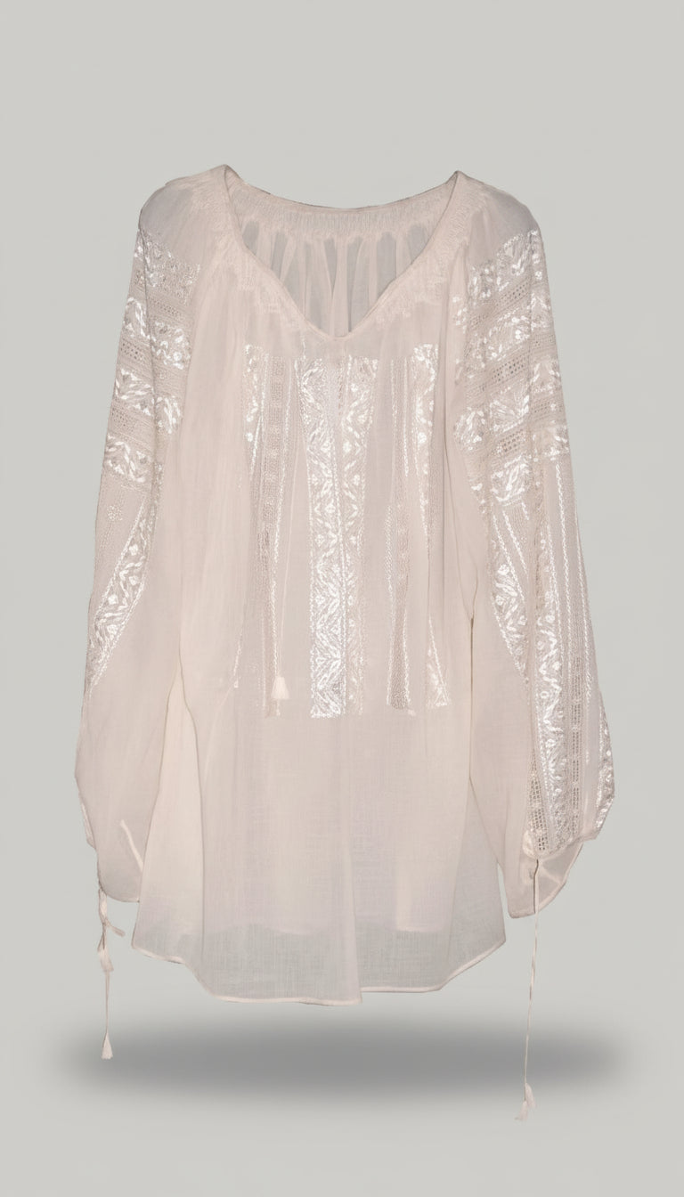 Sheer white blouse with long sleeves on a light gray background