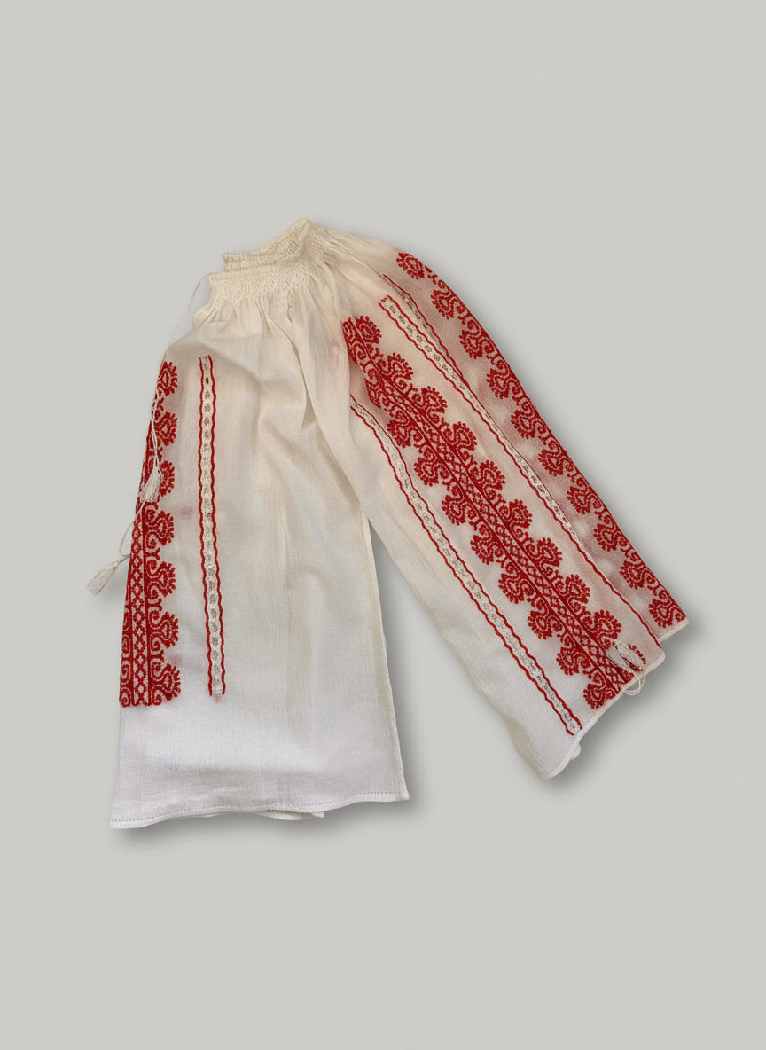 White pants with red embroidery on a light-colored surface