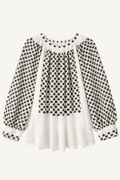 White blouse with black floral pattern on a white background
