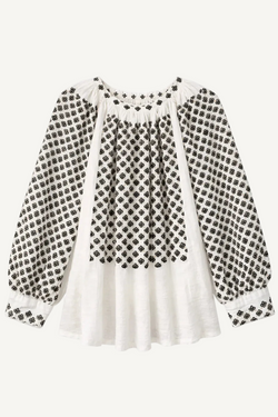 White blouse with black floral pattern on a white background