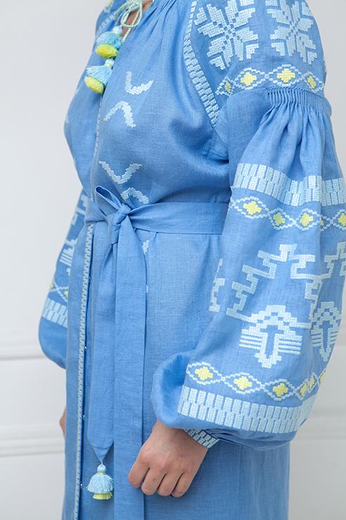 Model wearing the Tina blue embroidered linen midi dress