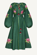 Green dress with floral embroidery on a white background