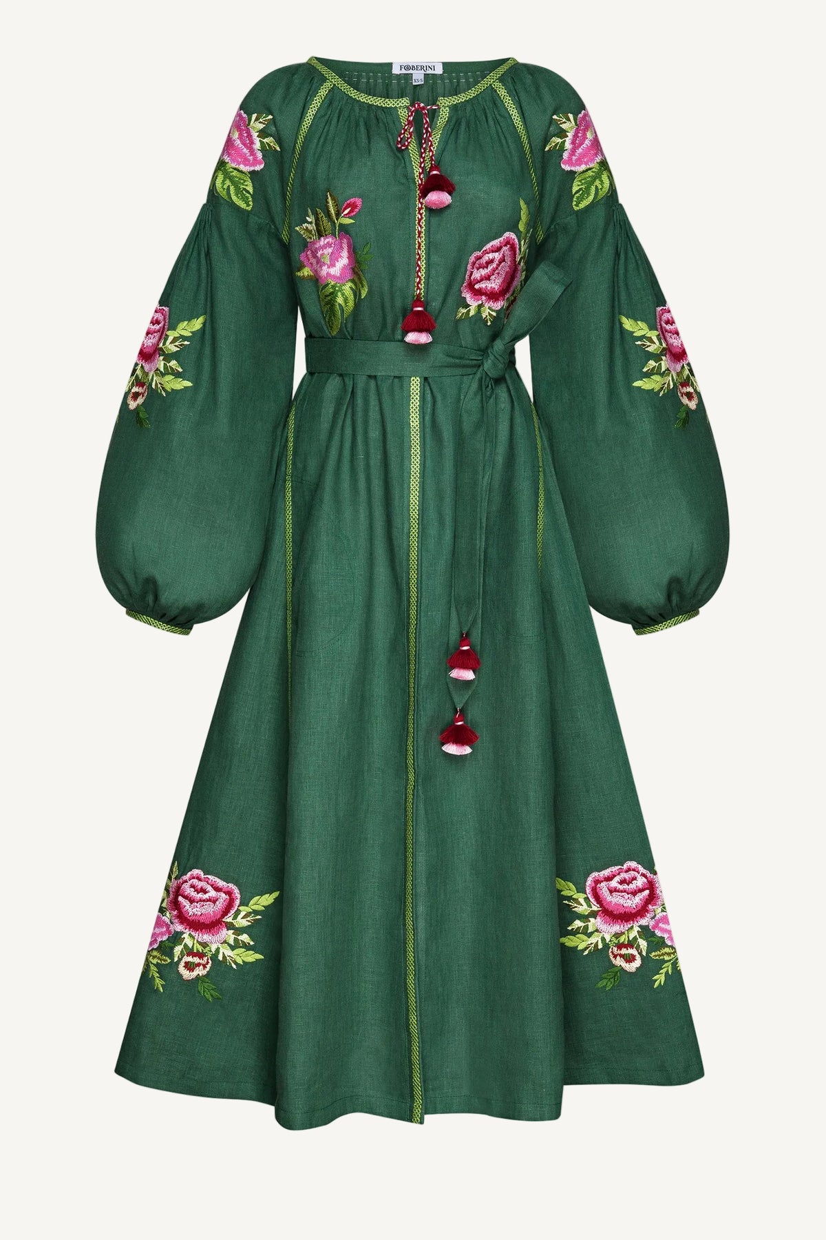 Green dress with floral embroidery on a white background
