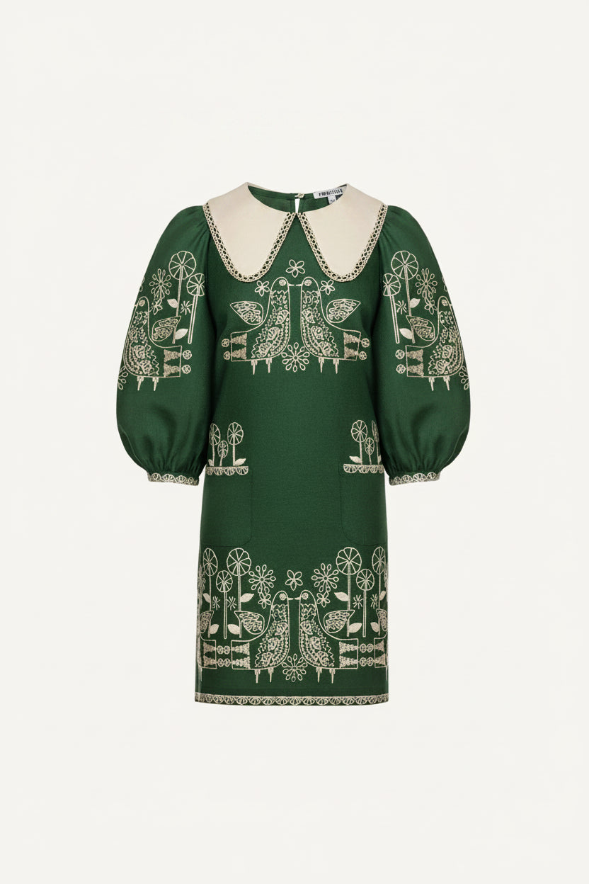Green dress with white embroidery on a white background
