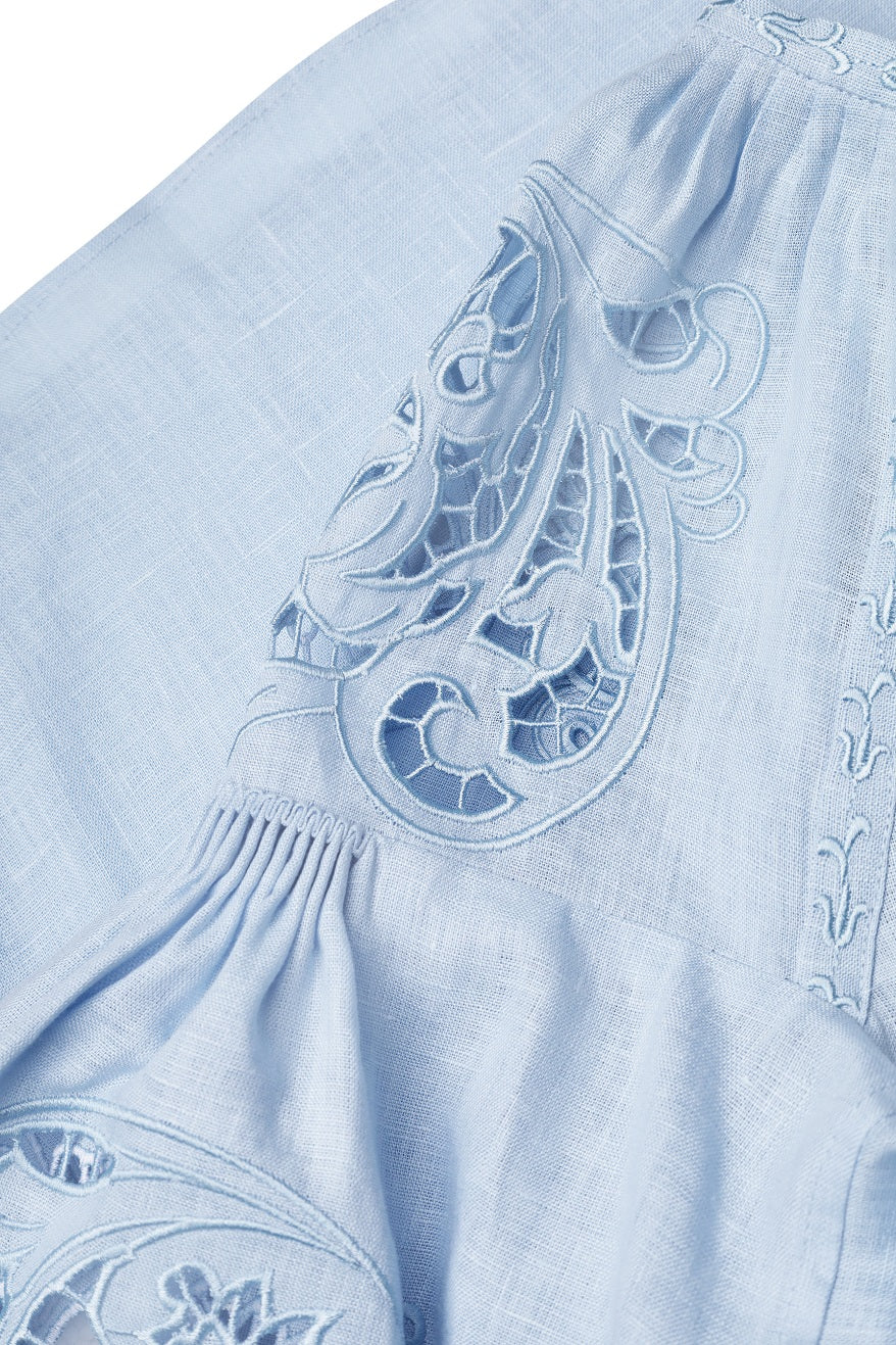 Blue linen blouse, handmade tassel neck ties and puff-stitched sleeves detail