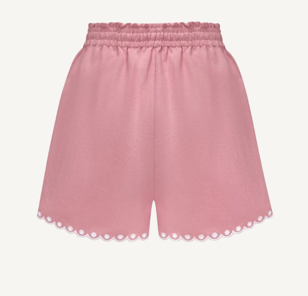 A pair of dusty pink shorts with an elastic waistband and scalloped eyelet lace trim along the hem, shown against a plain white background.