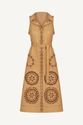 Beige sleeveless dress with intricate brown patterns on a white background