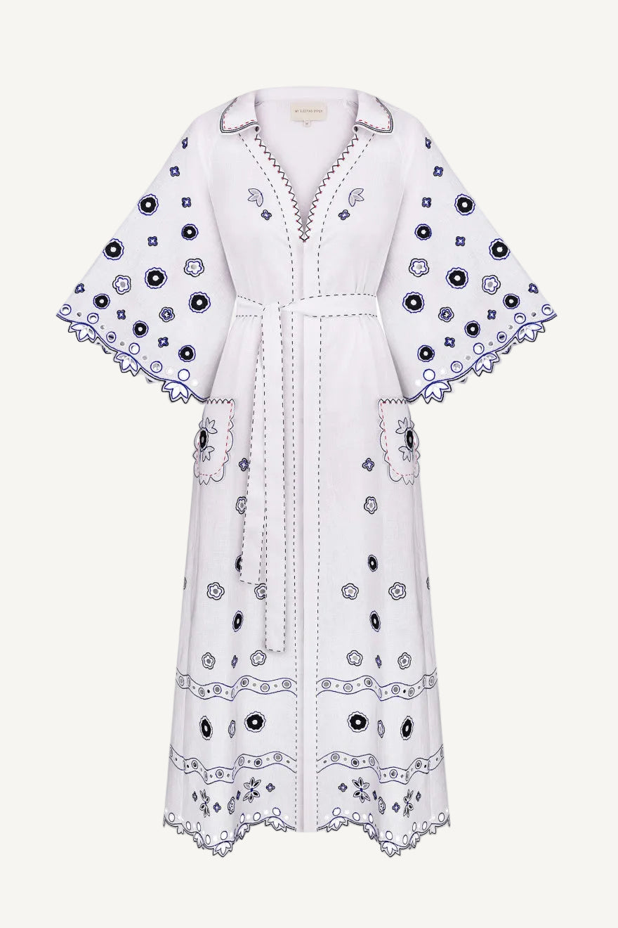 White dress with black floral embroidery The pattern is inspired by the painting Tiger Tiger Burning Bright by artist Beth Rodway, reinterpreted through artisanal craftsmanship.