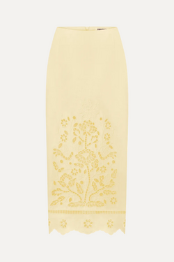 Yellow lace skirt with floral embroidery on a white background