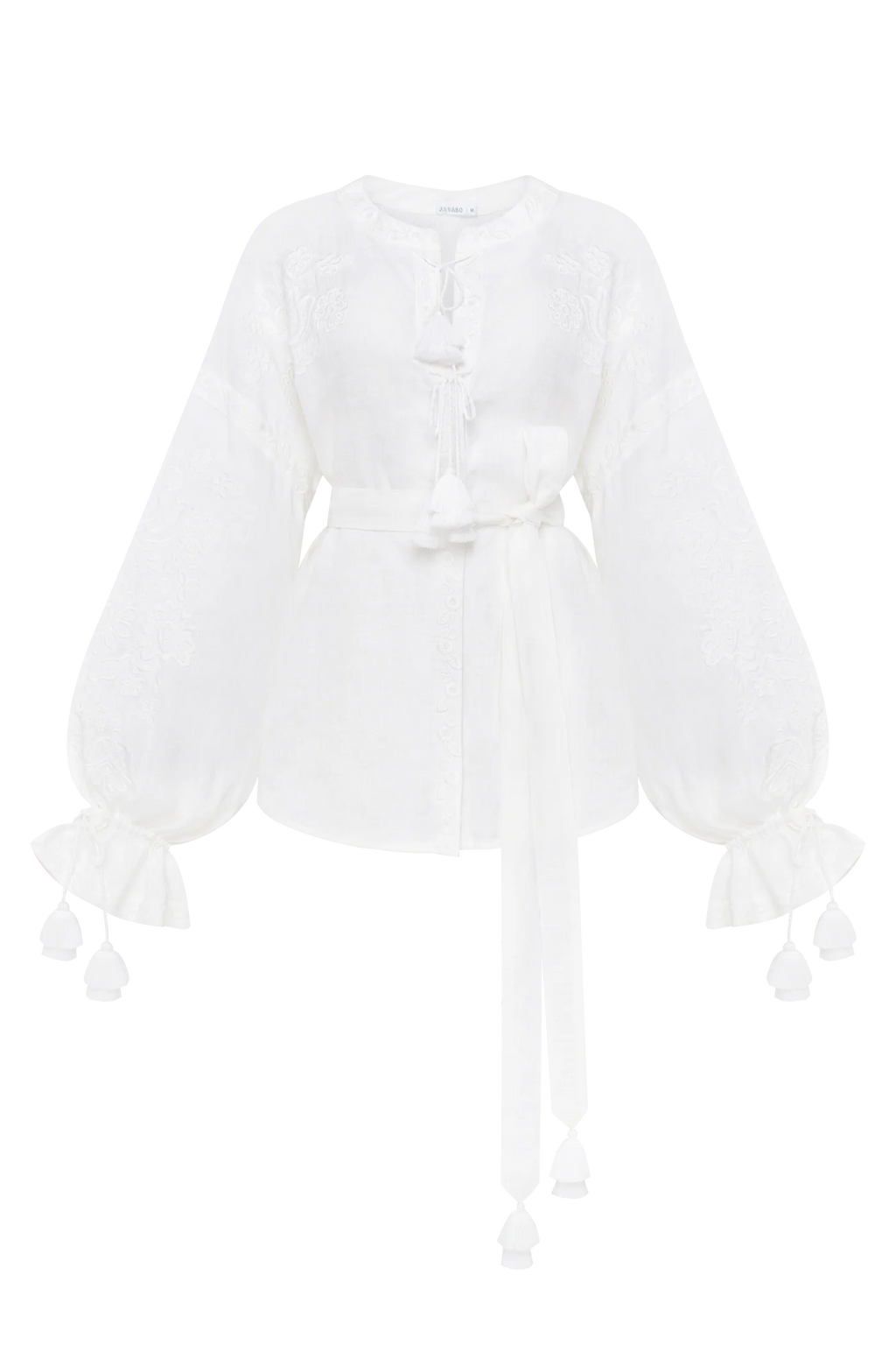 A white long-sleeve blouse with intricate lace embroidery, a tie-neck detail, a matching waist tie, and ruffled cuffs with tassel accents. Annabo designer, Blouse Roumaine Shop