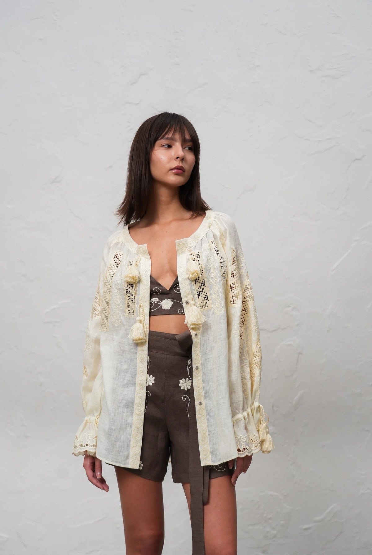 Hand-embroidered linen blouse in ivory Desert Rose handcrafted natural linen blouse with front embroidery and tassel ties by ANNABO.