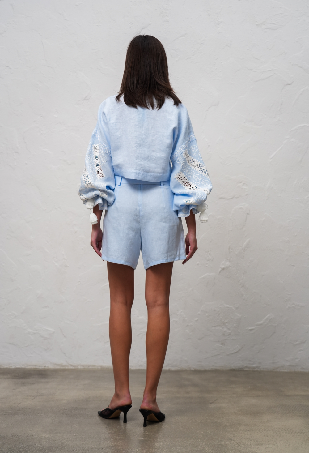 Hand-embroidered folk linen shorts in light blue – back view