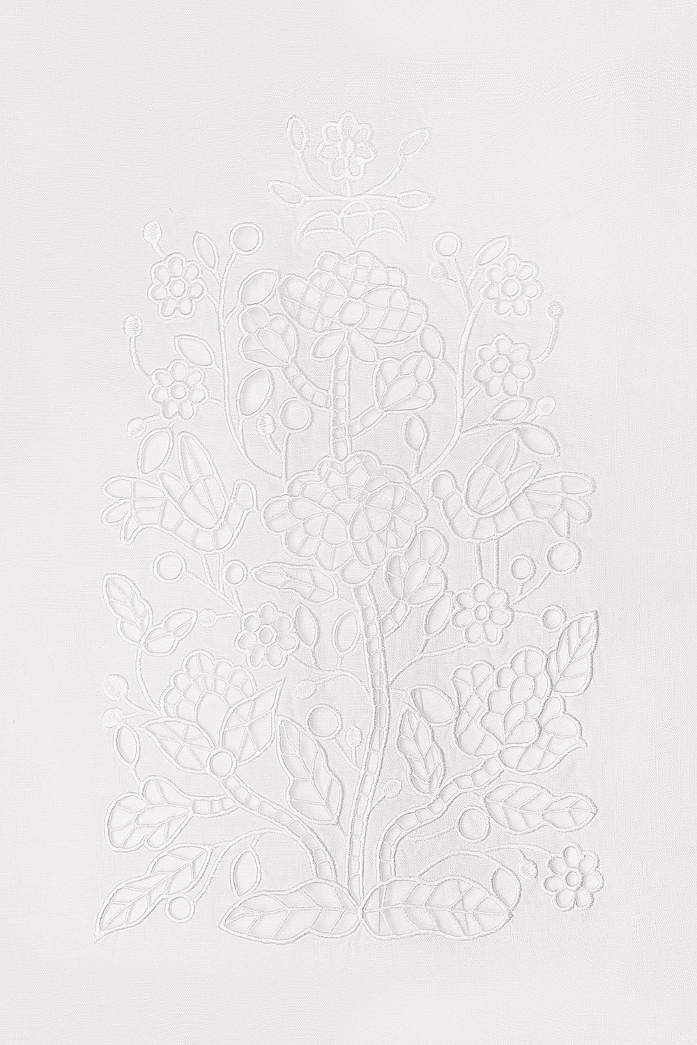 Decorative white floral pattern on a light gray background