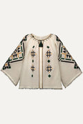 Traditional-style blouse with geometric patterns on a white background