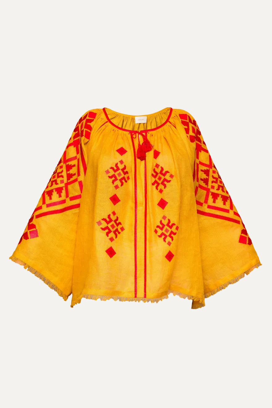 Yellow blouse with red patterns on a white background