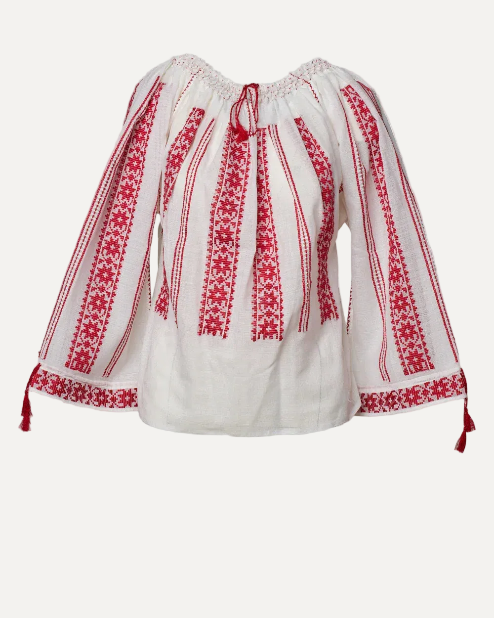 White blouse with red embroidery on a light gray background
