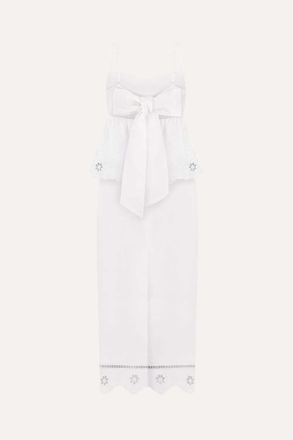 White dress with thin straps and decorative elements on a white background