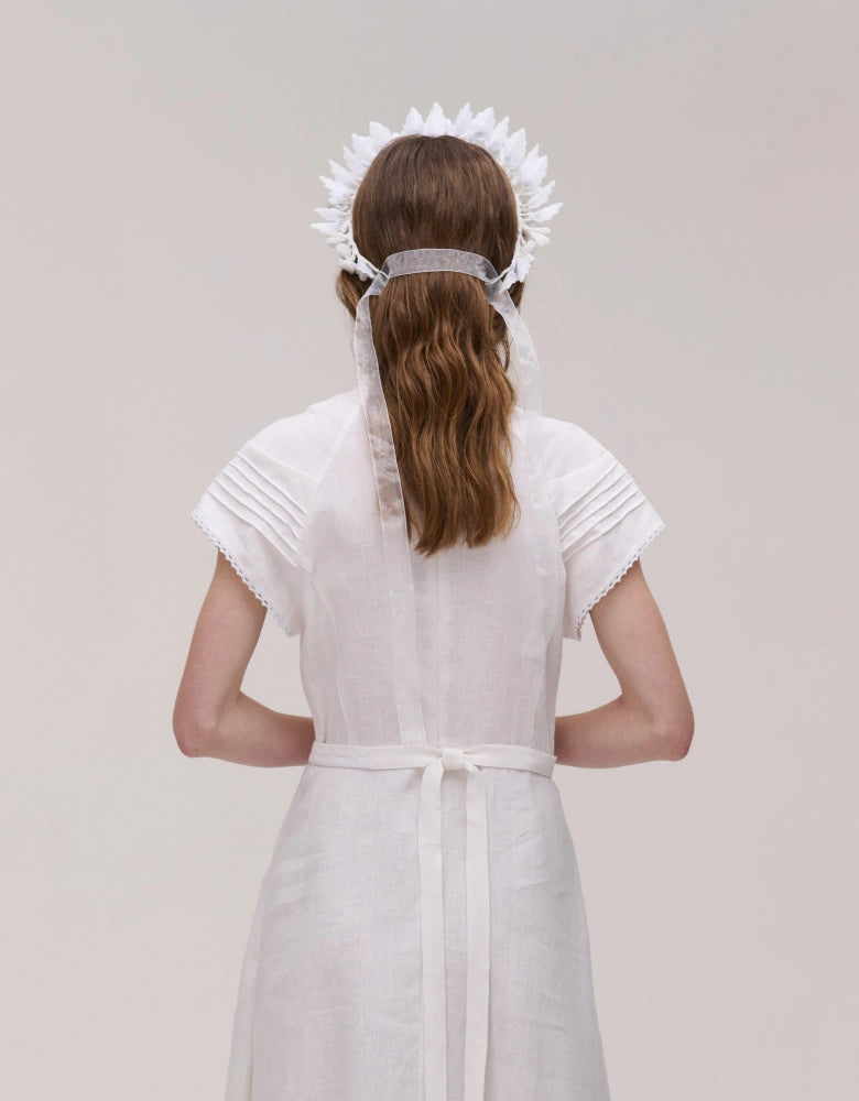 Model wearing the white Vinok bridal flower crown in wax blooms
