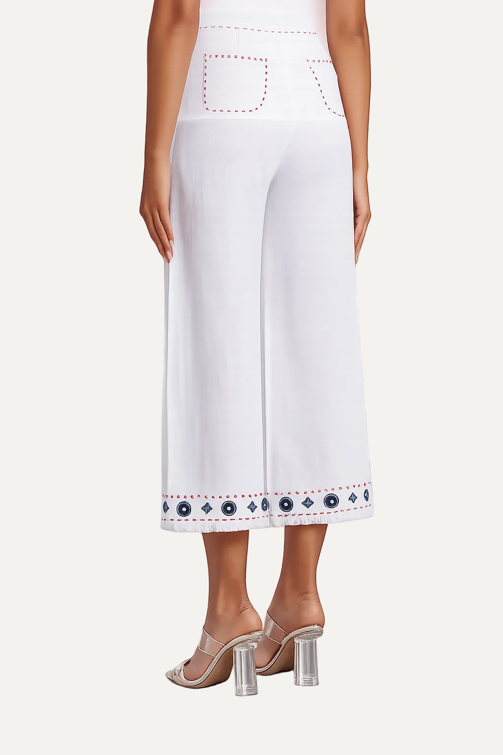 White pants with decorative hem on a white background