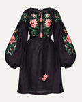 Black dress with floral embroidery on a white background