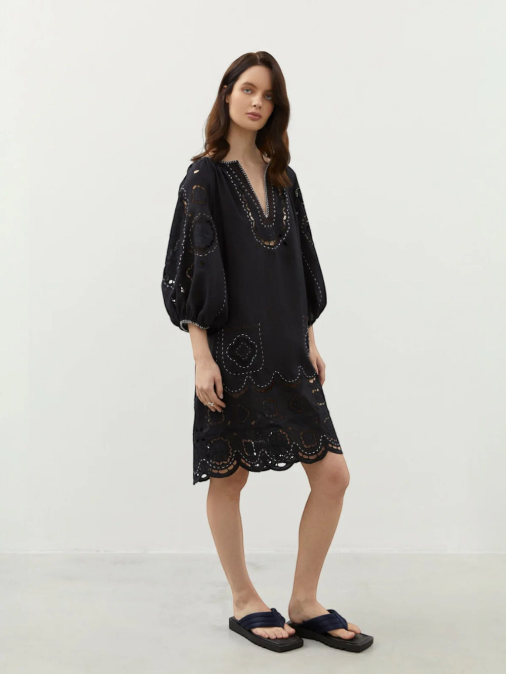 Model wearing the Merezhivo black linen mini dress