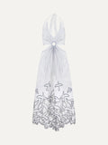 White halter neck dress with floral embroidery on a white background