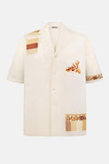 White shirt with embroidered patterns on a white background