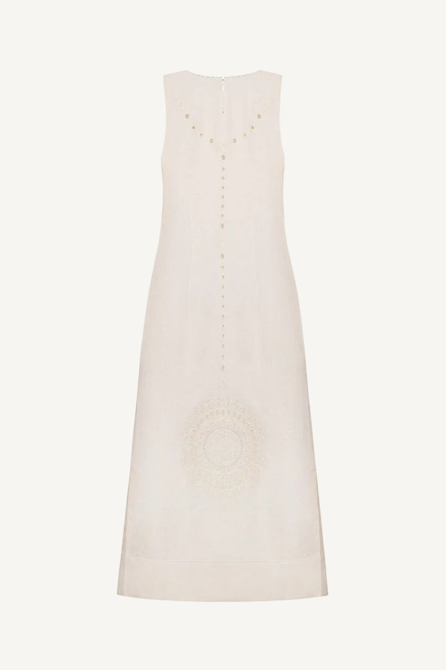 White sleeveless dress with decorative buttons on a white background