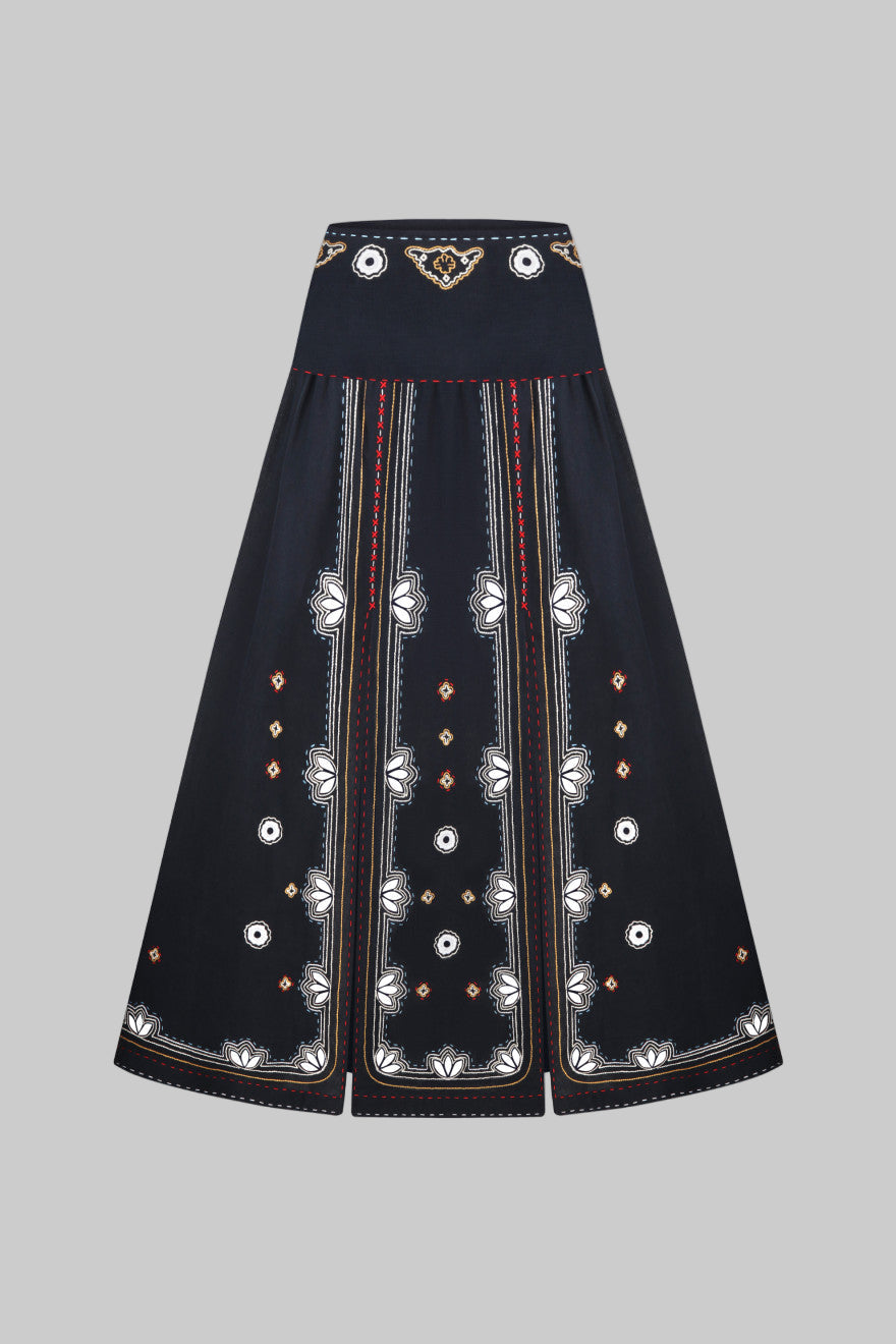 Black skirt with intricate white embroidery on a white background