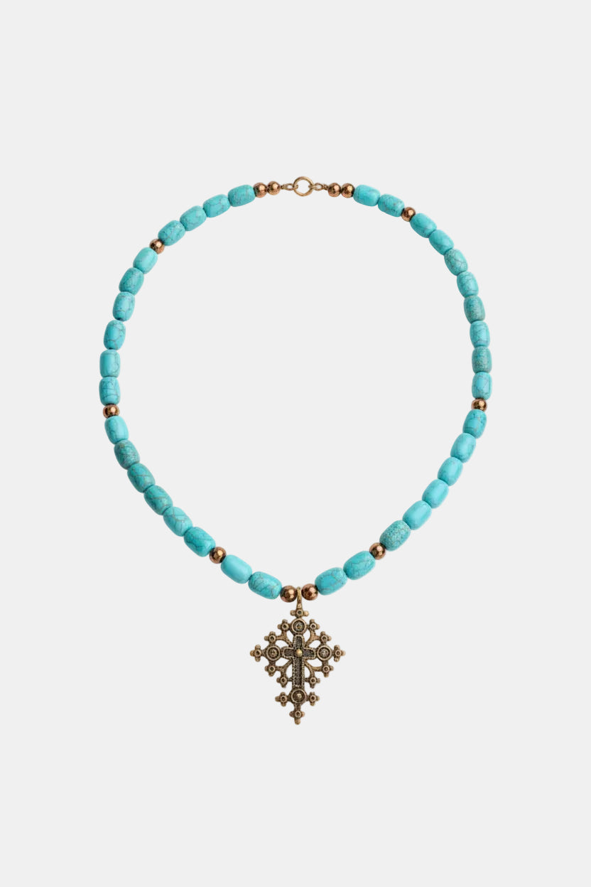 Turquoise beaded necklace with a decorative cross pendant