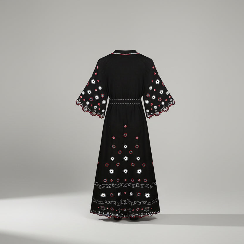 Black dress with colorful embroidery on a white background