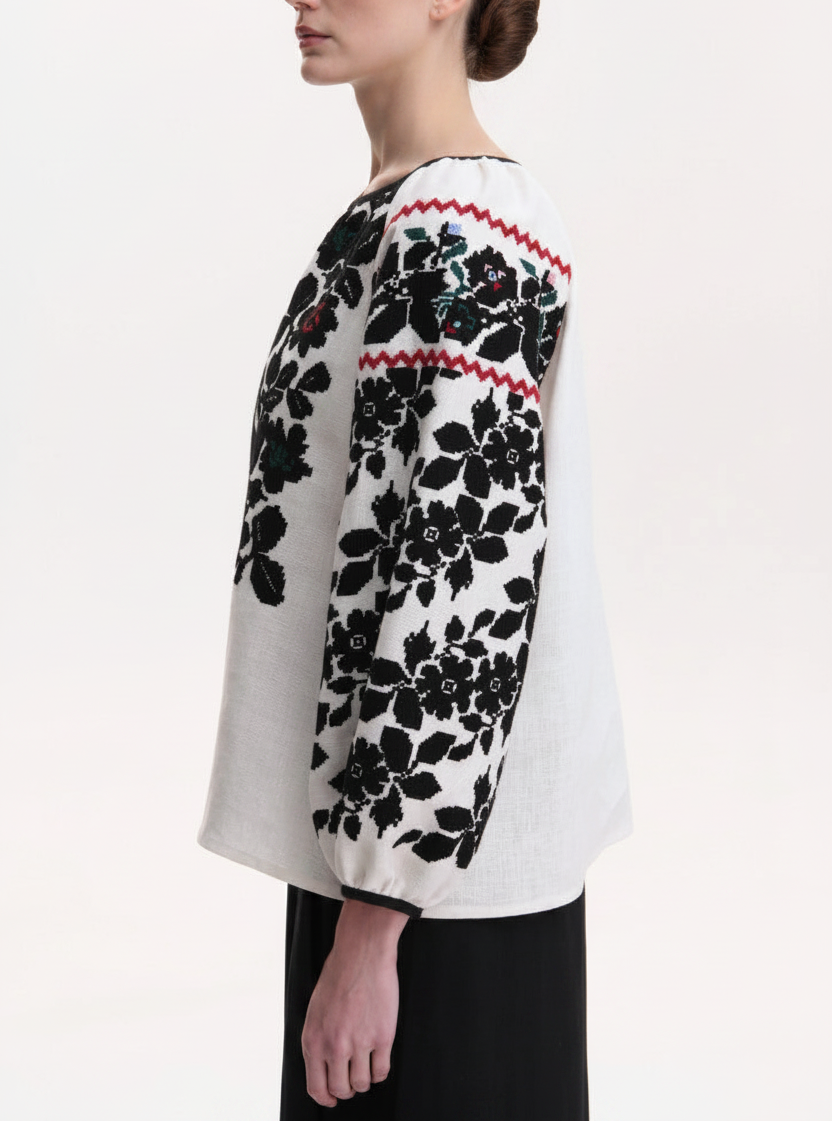 Sleeve detail of hand-embroidered floral Vyshyvanka blouse with black floral embroidery and red zigzag trim- Blouse Roumaine Shop